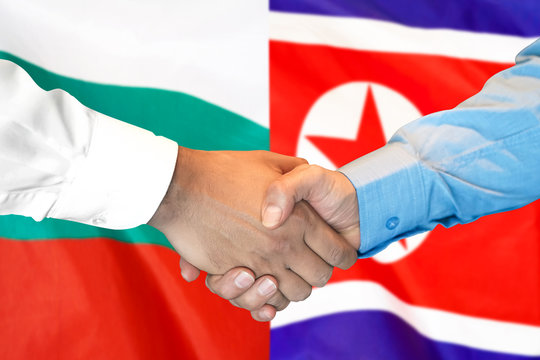 Business handshake on the background of two flags. Men handshake on the background of the Bulgaria and North Korea flag. Support concept