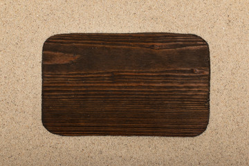 Wooden blank frame with on beach sand. Top view.