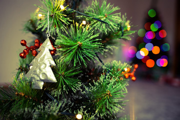 Decorated Christmas tree on blurred background.