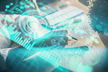 International business hud over woman's hands writing background. Concept of hard work. Double exposure