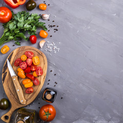 Ripe tomatoes for cooking vegetable dish on a gray background