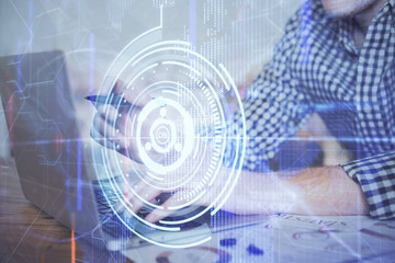 Businessman with computer background with technology theme hologram. Concept of hightech. Multi exposure.