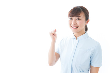 ガッツポーズをする若い看護師