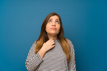 Fototapeta premium Young girl with striped shirt standing and thinking an idea