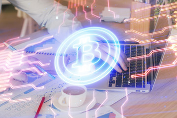 Crypto currency theme hologram with businessman working on computer on background. Concept of blockchain. Double exposure.