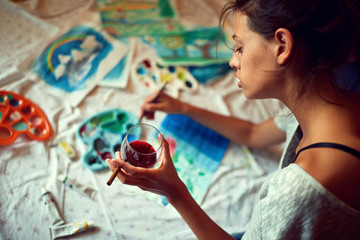 Woman hedonist painting with temperas