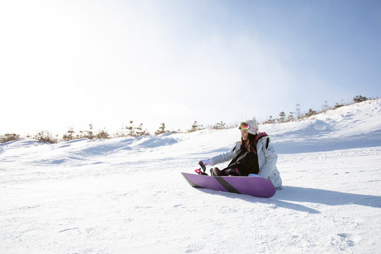 Happy young woman skiing in ski resort