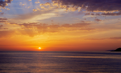 Naklejka na ściany i meble Bright sunrise over the sea.