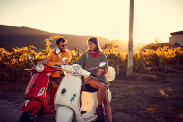 Romantic couple riding on a scooter and enjoying road trip. © luckybusiness