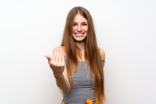 Young woman with long hair over isolated white wall inviting to come with hand. Happy that you came