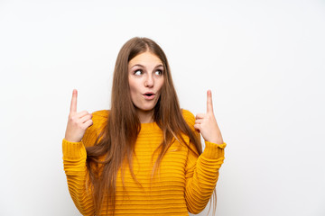 Young woman with yellow over isolated white wall pointing with the index finger a great idea