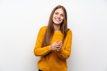 Young woman with yellow over isolated white wall applauding