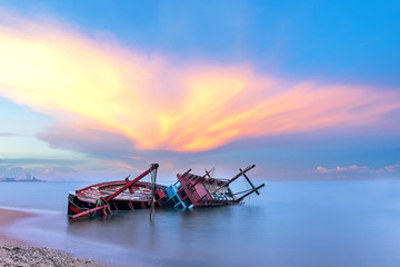 Shipwreck or wrecked boat on beach in the sunset. Beautiful Landscape. Pattaya Thailand