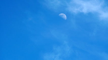 moon on a blue sky day