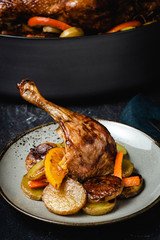 Roasted Goose Leg with Potatoes, Carrots and Oranges - 274435797