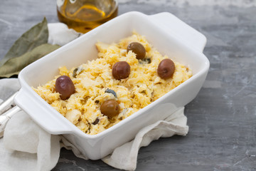 typical portuguese dish eggs with cod fish and olives in white dish Bacalhau a lisbonense