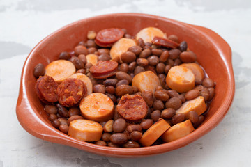 beans with smoked sausages and sausages in ceramic dish