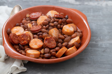 beans with smoked sausages and sausages in ceramic dish