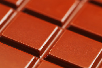 Milk chocolate close up. Segments of chocolate in the macro. Full frame texture