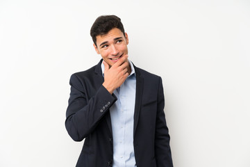 Handsome man over isolated white wall thinking an idea