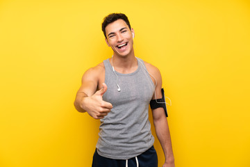 Handsome sport man over isolated background with thumbs up because something good has happened © luismolinero