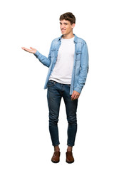 A full-length shot of a Handsome young man holding copyspace imaginary on the palm to insert an ad...