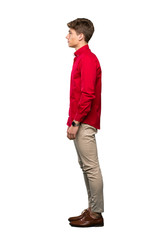 Fototapeta premium A full-length shot of a Handsome young man looking to the side over isolated white background