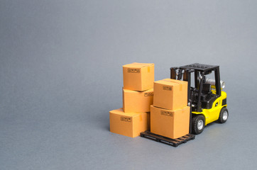 Yellow Forklift truck with cardboard boxes. Service storage of goods in a warehouse, delivery and transportation. Freight shipping, delivery. Import and export, commodity exchange with other countries