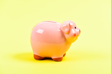 planning budget. financial problem. money saving. income management. piggy bank on yellow background. Time save Concept. Moneybox for coins with pig face. No to bribing. bribe