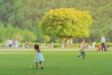Fototapeta premium Blur image of Kid enjoy to playing with little ball on green field