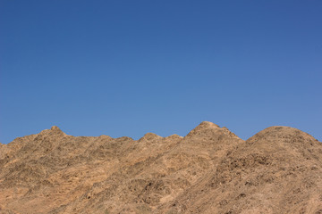 desert mountain ridge background pattern scenery landscape with empty blue sky and copy space for...