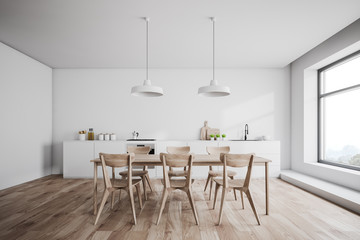 White kitchen interior with wooden table