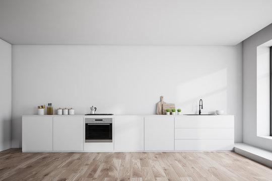 White countertops in white kitchen interior