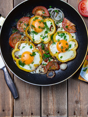 fried eggs with bacon and vegetables