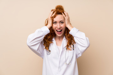 Redhead doctor woman with surprise facial expression