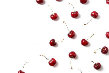 Obraz na płótnie Canvas Ripe red cherries arranged on white background isolated with copy space for text