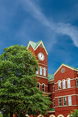 A red brick county courthouse with clock tower