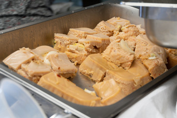 Nigerian Moi Moi or Bean Cake in Chaffing Dish at Party