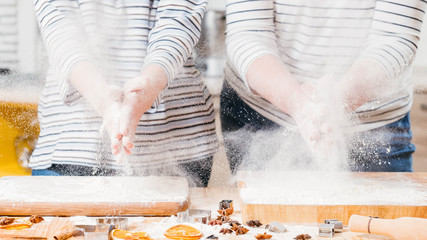 Culinary master class. Cropped shot of women slapping hands, shacking off flour.