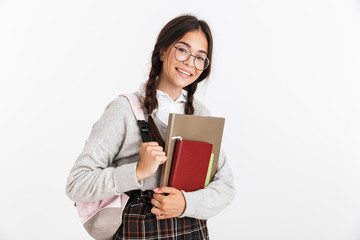 Photo closeup of happy teenage girl wearing eyeglasses stressing and grabbing her head while holding studying books
