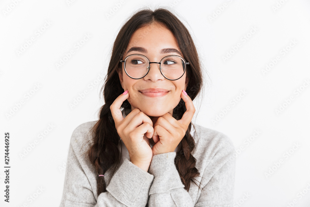 Canvas Prints Photo closeup of caucasian teenage girl wearing eyeglasses smiling and pointing fingers at her cheeks