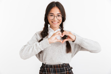 Photo closeup of caucasian teenage girl wearing eyeglasses and school uniform smiling while showing heart shape with fingers