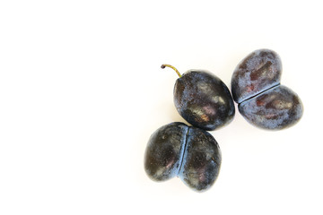 Abnormal plums, folded in the form of a butterfly with the text space on white background
