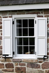 Fototapeta premium This window has bright white window shutters.