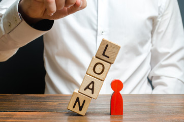 Man pushes downs a cube tower with the word Loan on the red man figure. Lack of protection for...