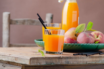Fresh homemade peach juice in glass for breakfast on wooden table .Rustic stile. Free text space.