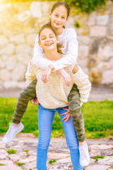 Two Young Girls Playing A Game Together At Sunny Day. Best Friends Having Fun In The Summer Riding...