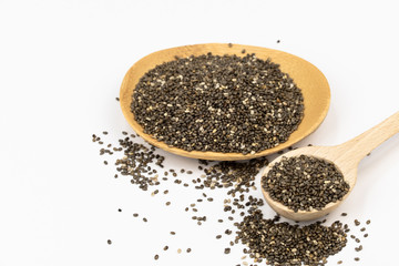 chia seeds bamboo bawl and wooden spoon white background