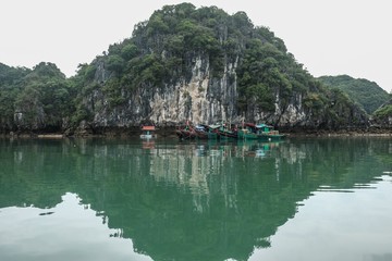 floating village at Cat Ba island Vietnam - limestone cliffs fishing boats and houses