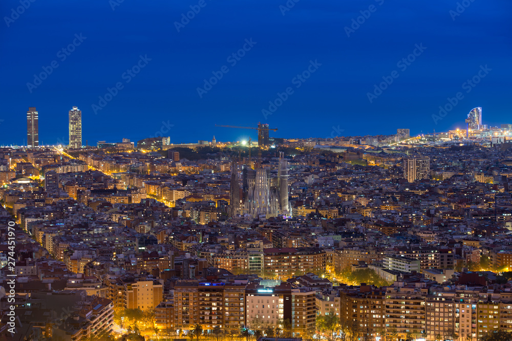 Wall mural Top view of Barcelona city skyline during evening in Barcelona, Catalonia, Spain..